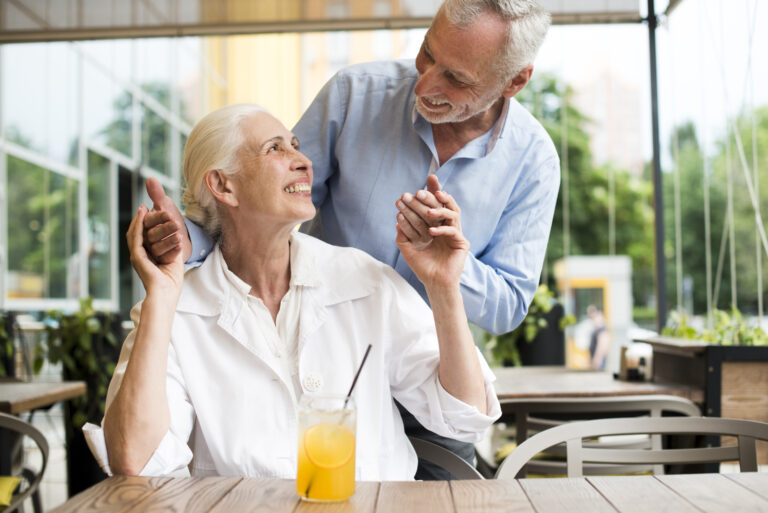 medium shot smiley couple looking each other